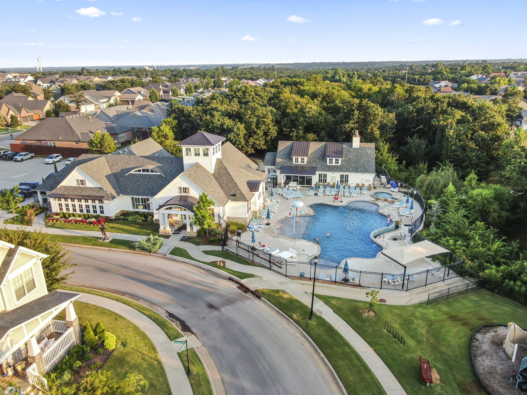 Aerial drone view of a neighborhood clubhouse and pool amenity