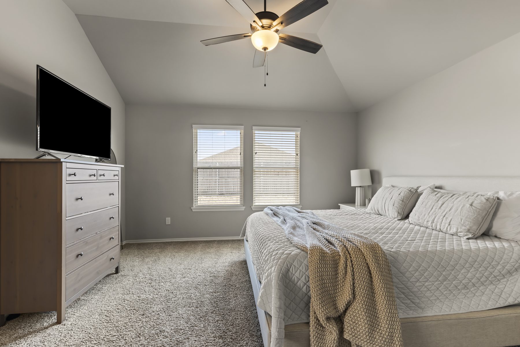 Bright primary bedroom suite with natural light